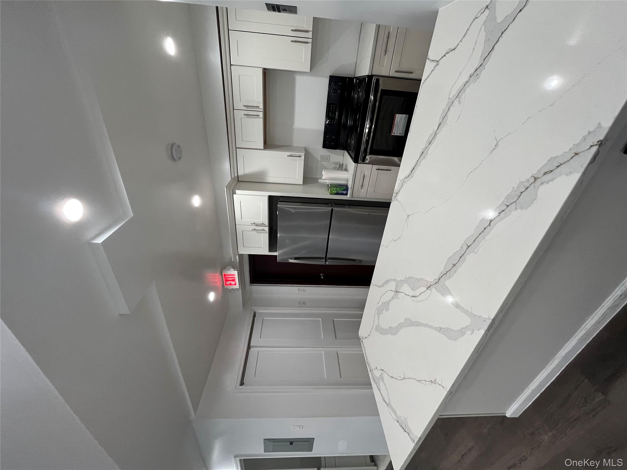 2545 Sedgwick Avenue, Unit 7B Bronx, NY 10468 - Photo 19 of 20 a kitchen with stainless steel appliances a refrigerator and a stove top oven