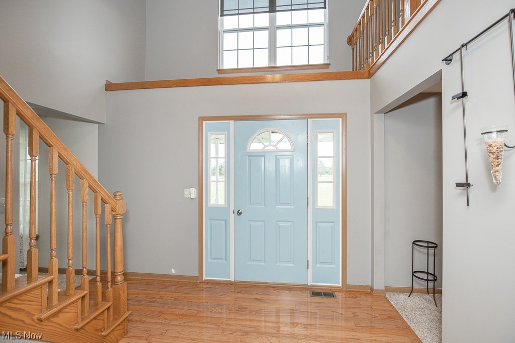 9708 Reed Road Grafton, OH 44044 - Photo 4 of 35 Entrance foyer with a towering ceiling and light hardwood / wood-style flooring