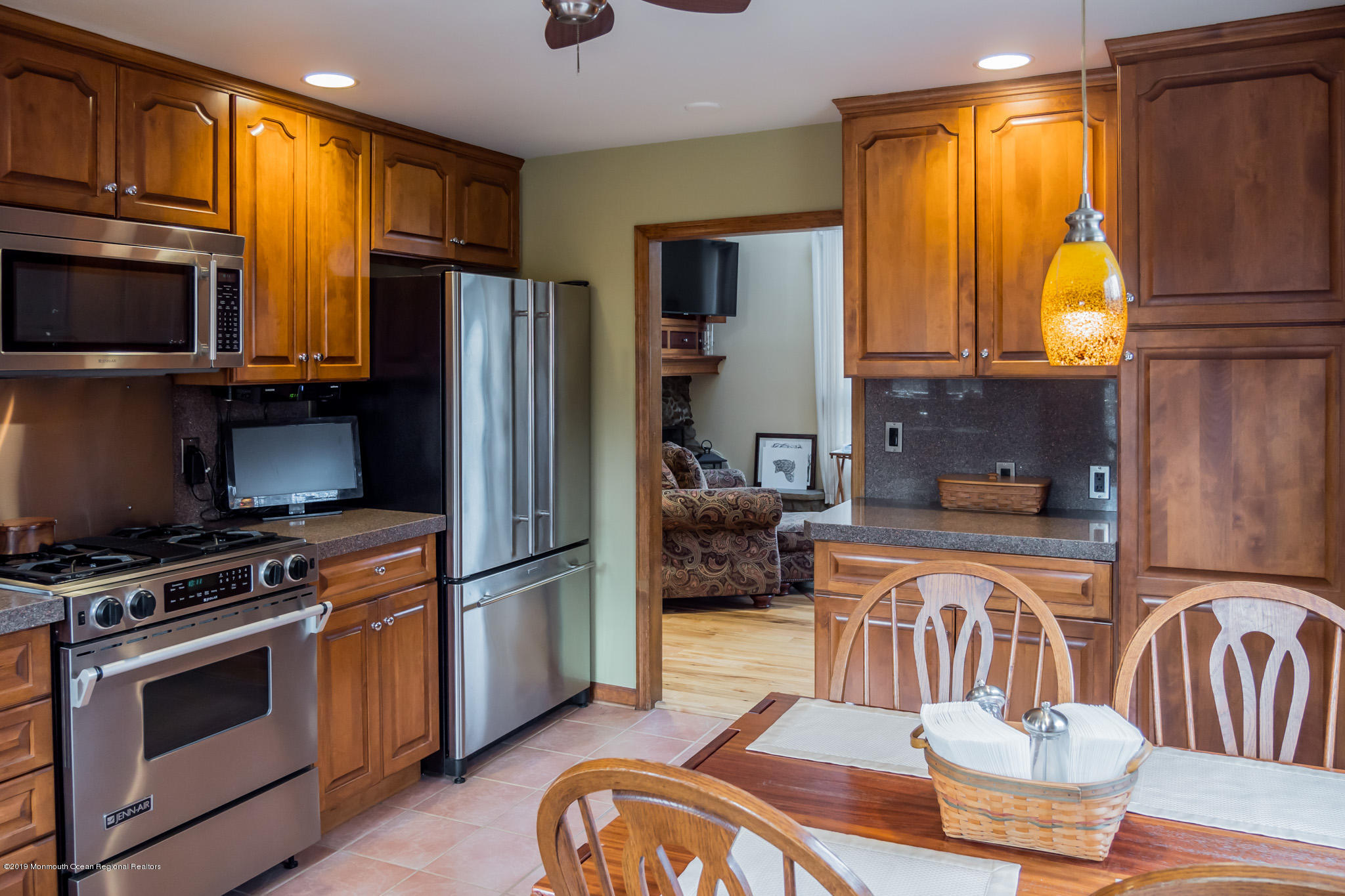20 Ridge Road Hopatcong, NJ 07843 - Photo 11 of 30 a kitchen with stainless steel appliances granite countertop a refrigerator a stove a sink dishwasher a dining table and chairs with wooden floor