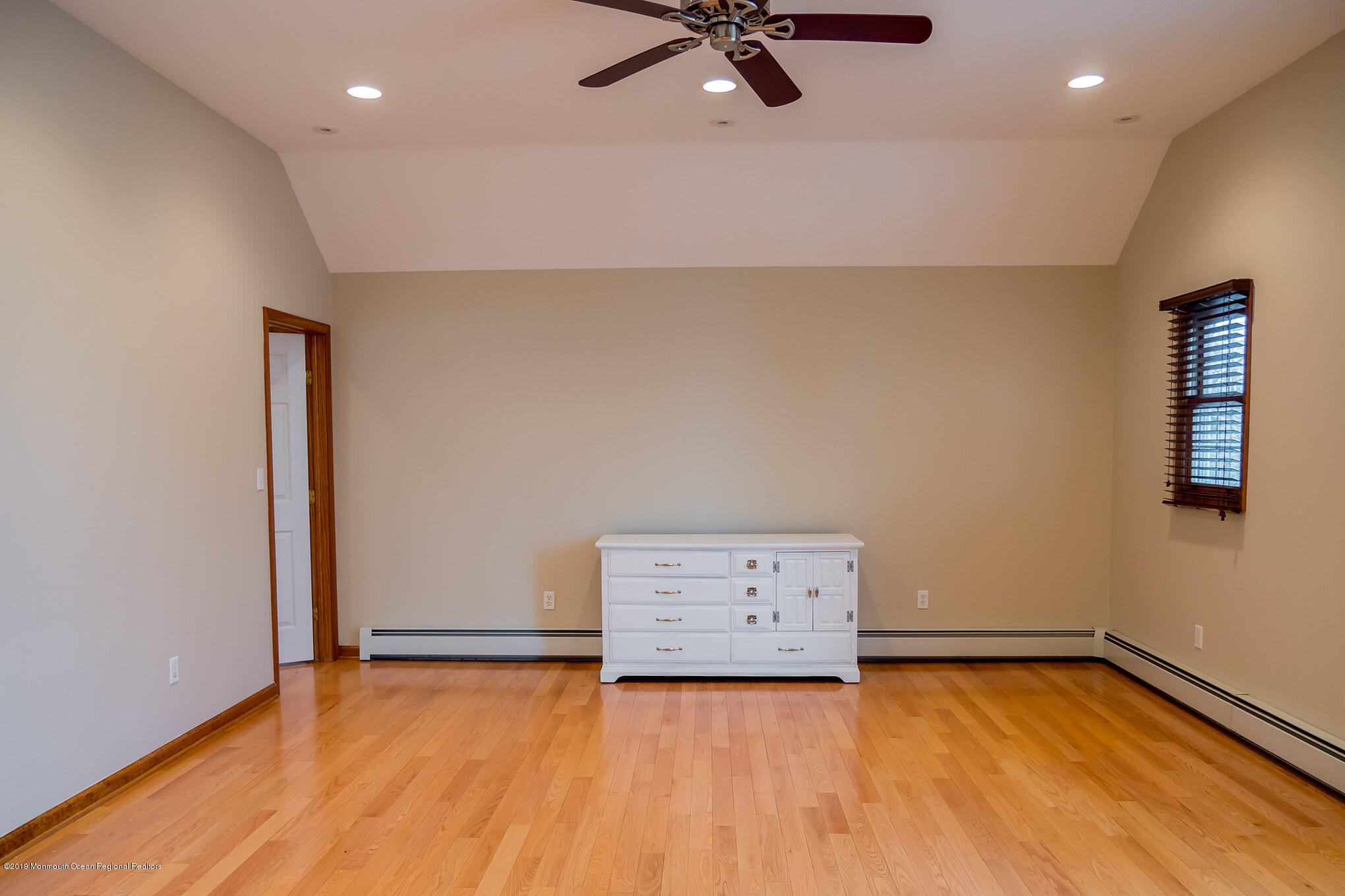 20 Ridge Road Hopatcong, NJ 07843 - Photo 23 of 30 an empty room with a ceiling fan and wooden floor