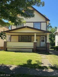 Back of property featuring a porch and a lawn
