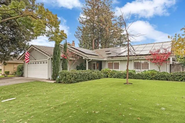 a front view of a house with a garden