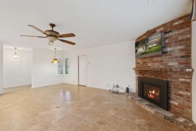 a view of an empty room and fire place