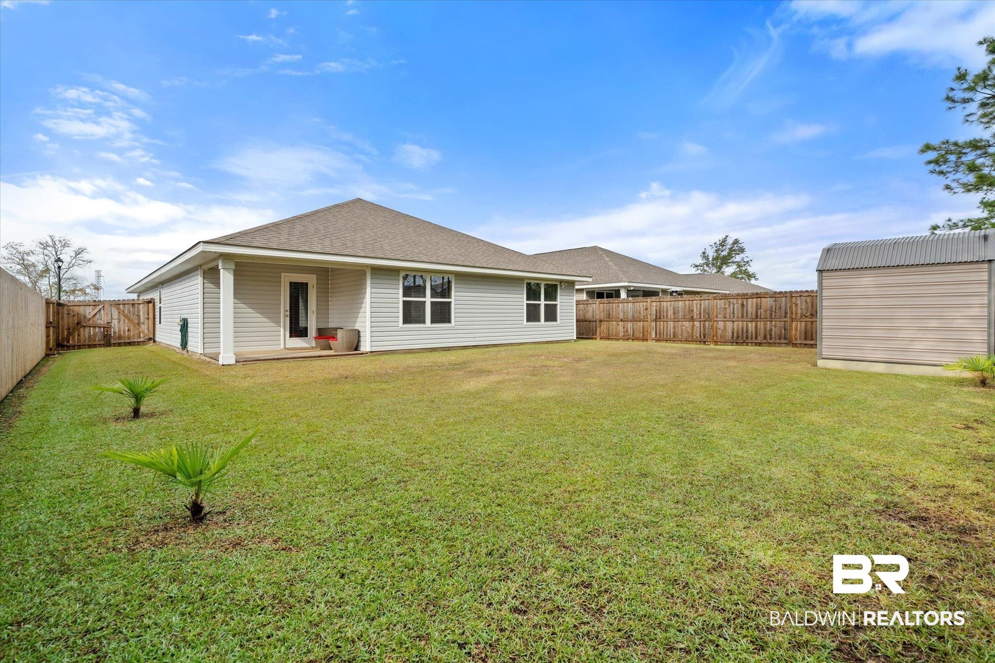 446 Paget Drive East Mobile, AL 36608 - Photo 18 of 20 Rear view of property with a yard and a shed