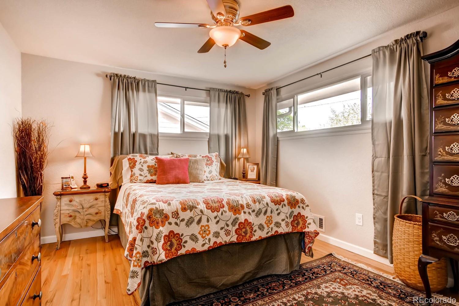 3660 Hoyt Court Wheat Ridge, CO 80033 - Photo 11 of 28 a bedroom with a bed and a chandelier