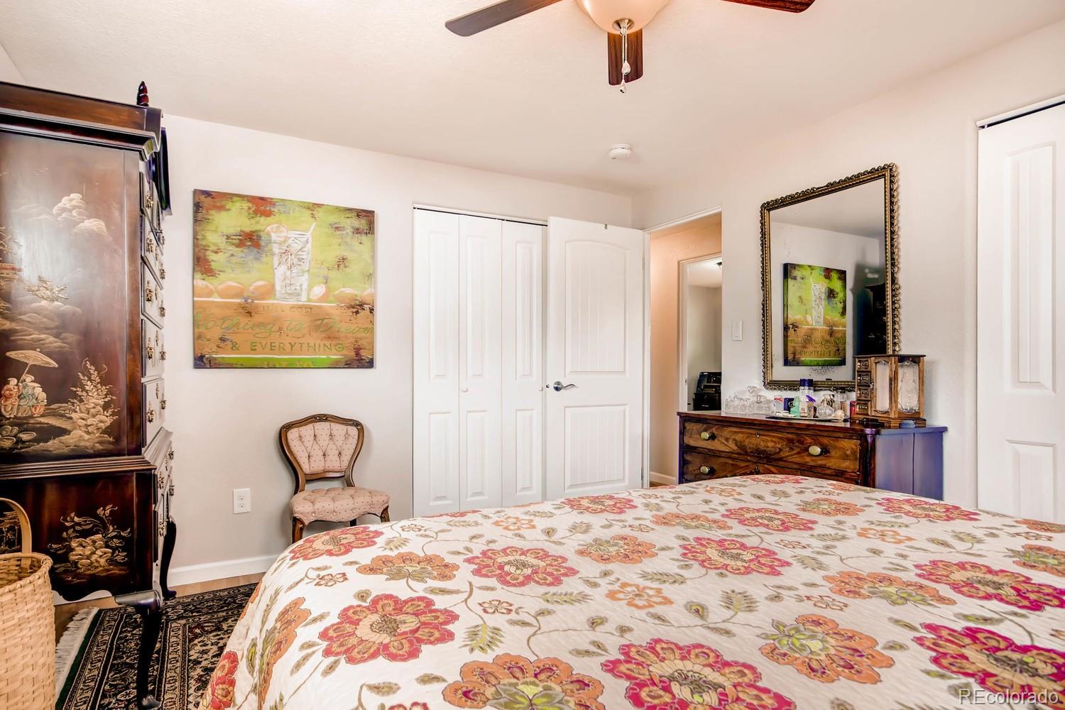 3660 Hoyt Court Wheat Ridge, CO 80033 - Photo 12 of 28 a bedroom with a bed and a dresser with mirror