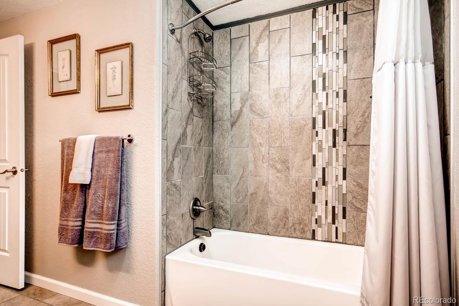 3660 Hoyt Court Wheat Ridge, CO 80033 - Photo 14 of 28 a bathroom with a bathtub and shower