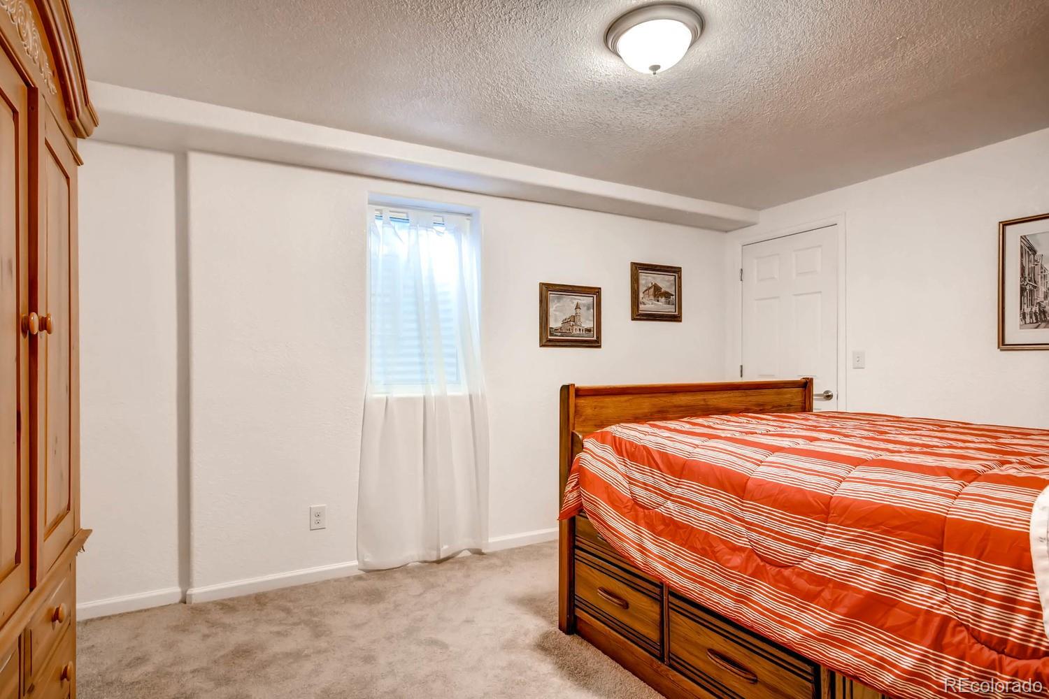 3660 Hoyt Court Wheat Ridge, CO 80033 - Photo 20 of 28 a bedroom with a bed and a window
