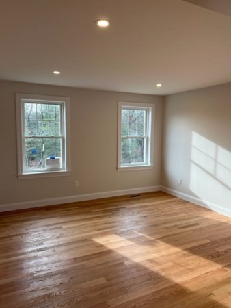 178 Andover Road Billerica, MA 01821 - Photo 20 of 39 an empty room with wooden floor and windows