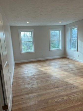 178 Andover Road Billerica, MA 01821 - Photo 23 of 39 an empty room with wooden floor and windows
