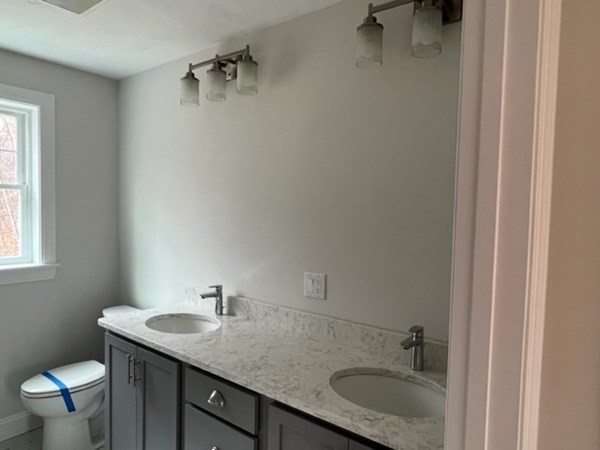 178 Andover Road Billerica, MA 01821 - Photo 29 of 39 a bathroom with a granite countertop sink a mirror and a toilet