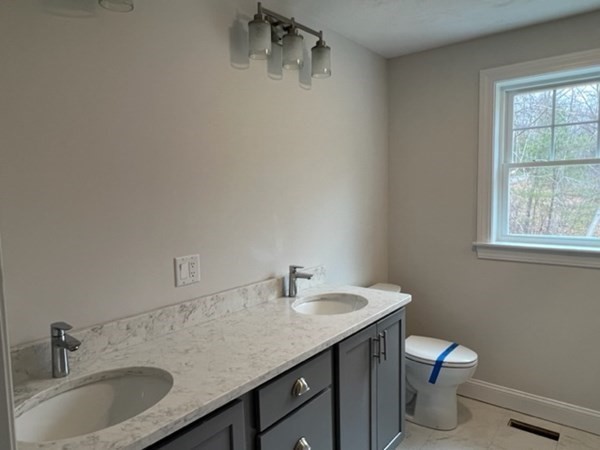 178 Andover Road Billerica, MA 01821 - Photo 30 of 39 a bathroom with a granite countertop sink a toilet and a window