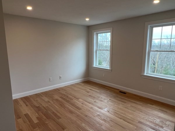 178 Andover Road Billerica, MA 01821 - Photo 34 of 39 an empty room with wooden floor and windows