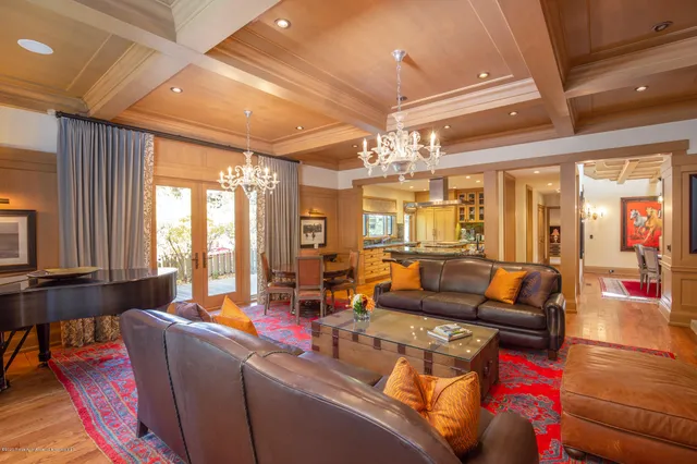 a living room with furniture and a chandelier