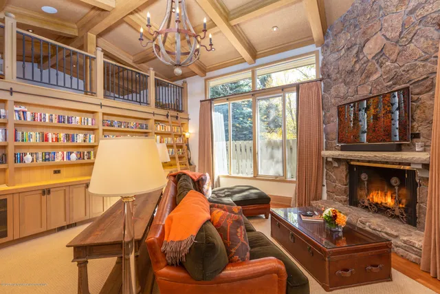 a living room with furniture fireplace and flat screen tv