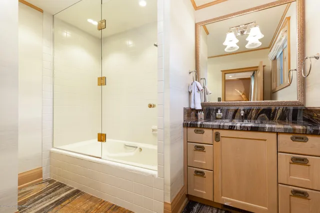 a bathroom with a bathtub a sink and a mirror