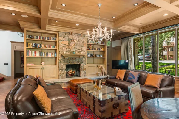 a living room with furniture and a chandelier