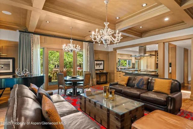 a living room with furniture a dining table and a fireplace