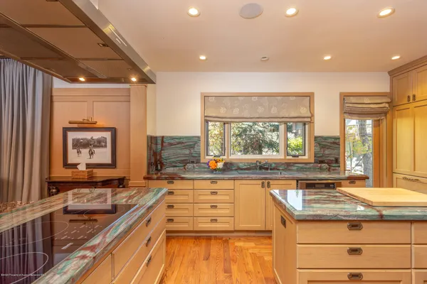 a kitchen with stainless steel appliances granite countertop a stove and a sink