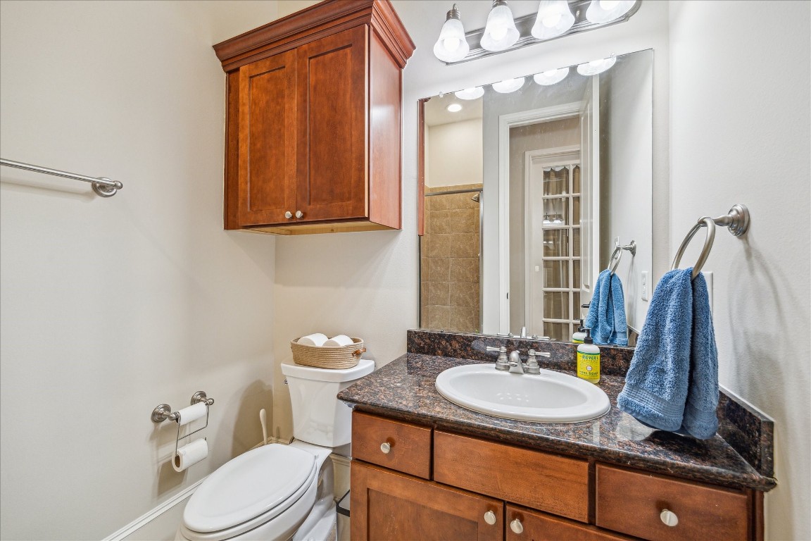 1046 West 23rd Street, Unit C Houston, TX 77008 - Photo 11 of 15 a bathroom with a granite countertop sink toilet and a mirror