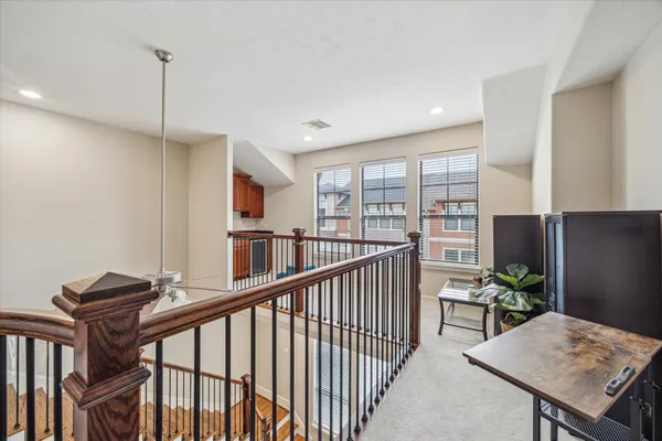 a view of a hallway with furniture