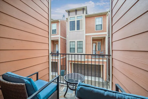 a view of a balcony with furniture