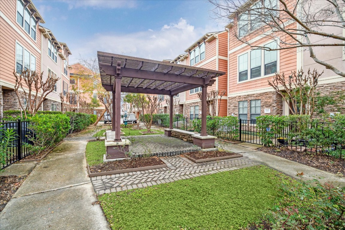 1046 West 23rd Street, Unit C Houston, TX 77008 - Photo 2 of 15 a view of a patio with a table and chairs under an umbrella