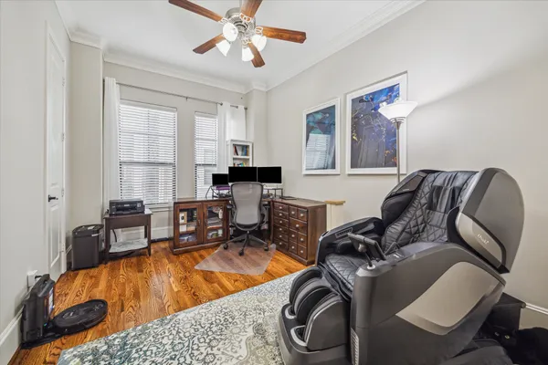 a room with furniture or chandelier and a wooden floor