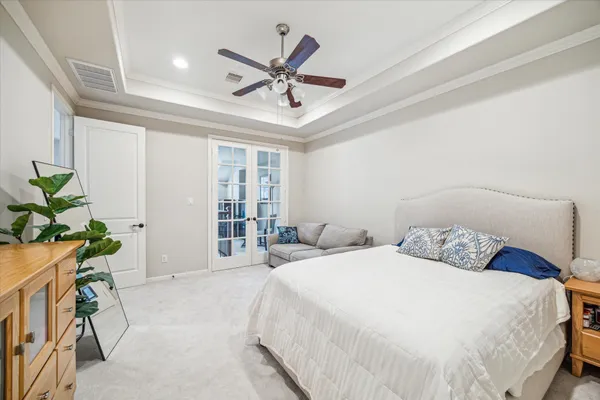 a bedroom with a large bed and a chandelier