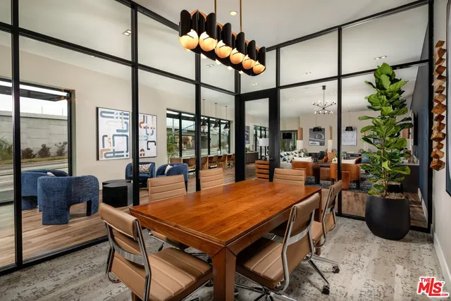 a dining room with furniture window and wooden floor