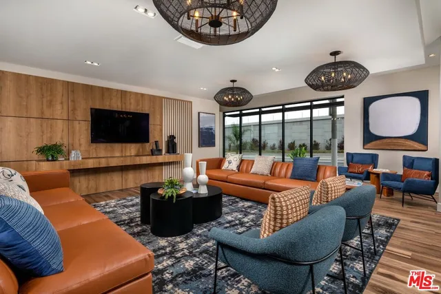 a living room with furniture a rug and a flat screen tv