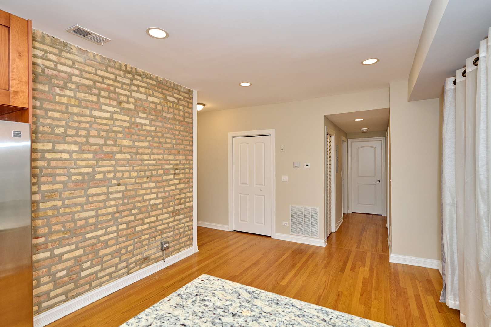 5715 North Kimball Avenue, Unit 1N Chicago, IL 60659 - Photo 14 of 36 a view of a bathroom with a sink and a wooden floor