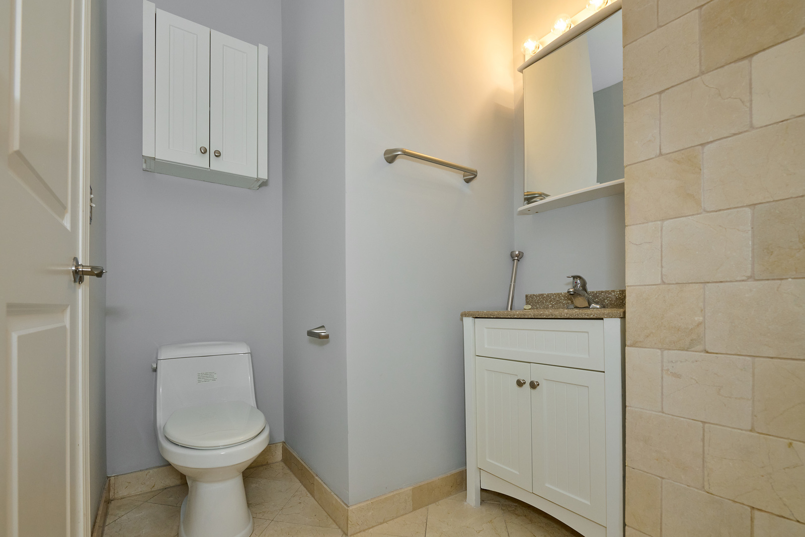 5715 North Kimball Avenue, Unit 1N Chicago, IL 60659 - Photo 23 of 36 a bathroom with a sink a toilet and mirror