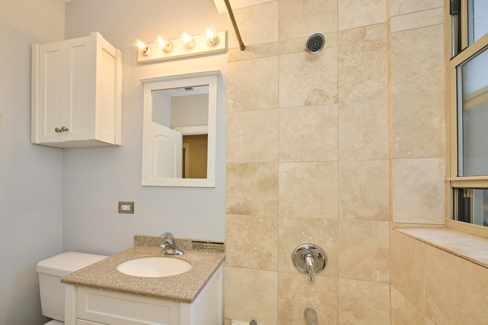 5715 North Kimball Avenue, Unit 1N Chicago, IL 60659 - Photo 27 of 36 a bathroom with a sink vanity granite and shower