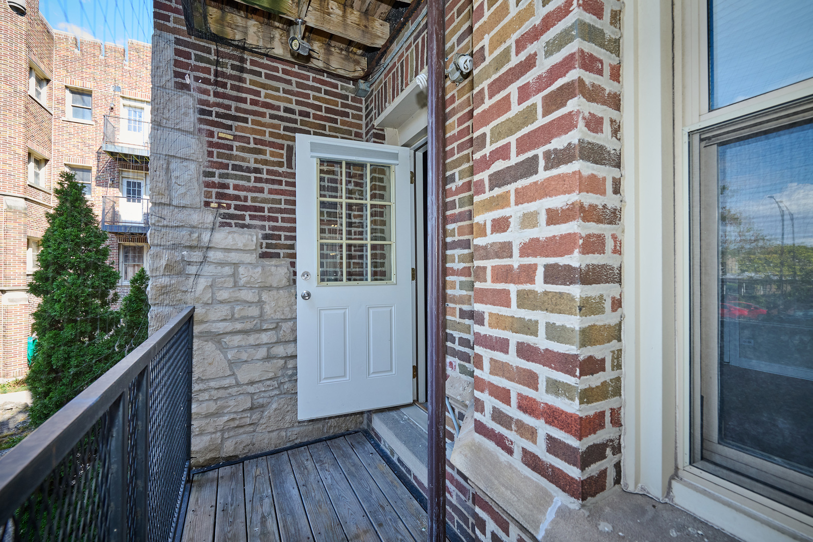 5715 North Kimball Avenue, Unit 1N Chicago, IL 60659 - Photo 30 of 36 a view of a balcony with wooden floor and fence
