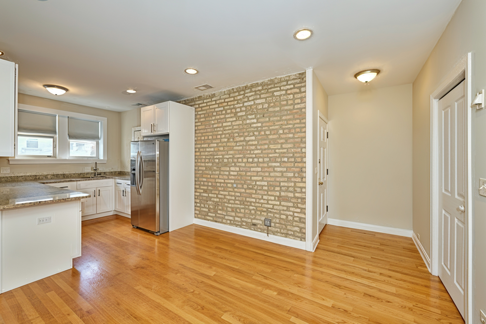 5715 North Kimball Avenue, Unit 1N Chicago, IL 60659 - Photo 7 of 36 a view of a kitchen with a sink and a refrigerator