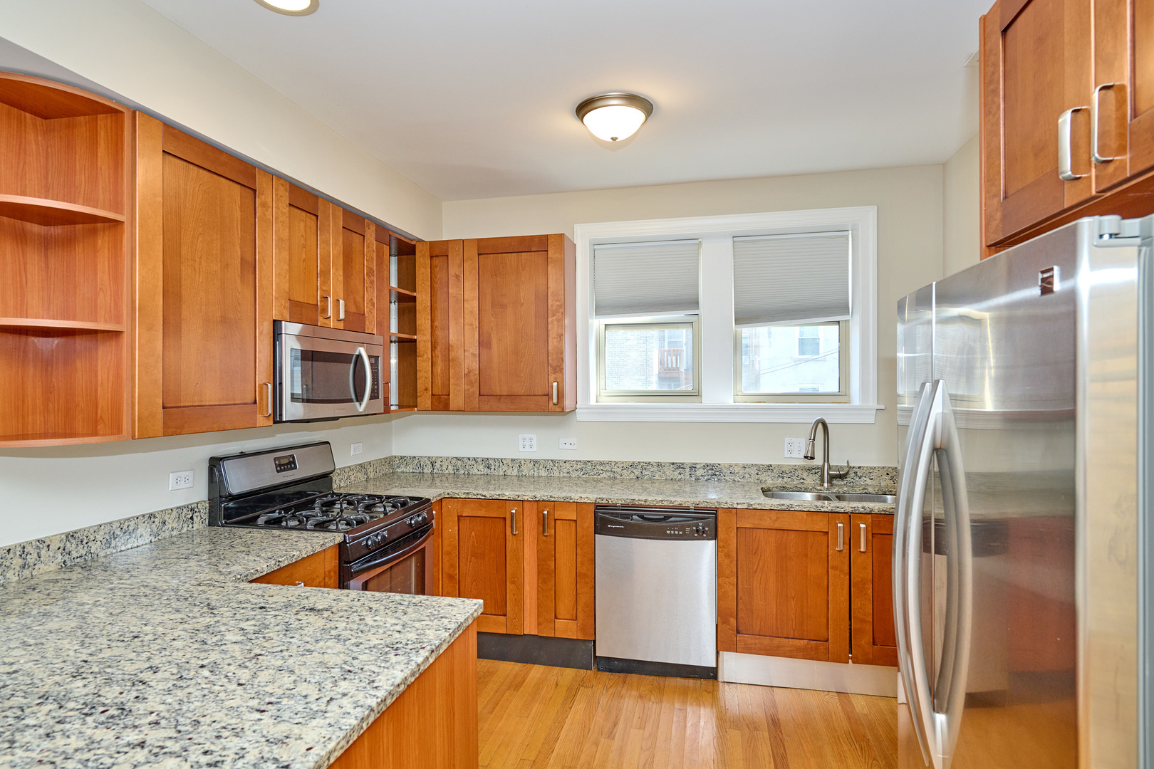 5715 North Kimball Avenue, Unit 1N Chicago, IL 60659 - Photo 8 of 36 a kitchen with stainless steel appliances granite countertop a sink stove and refrigerator