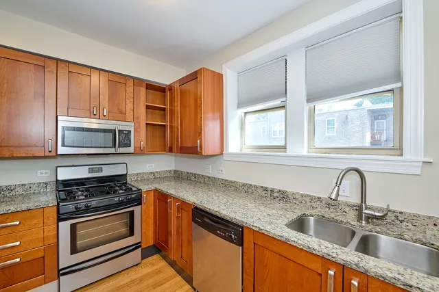 a kitchen with wooden cabinets and a stove top oven