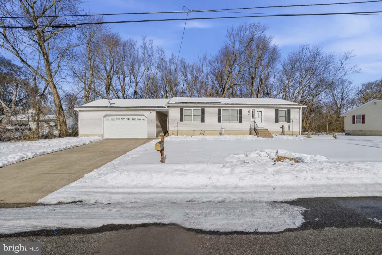 a view of a house with snow on the road