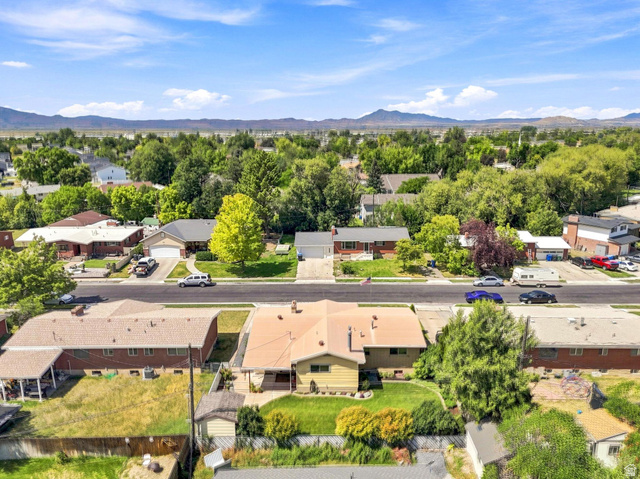 702 North 150 West Logan, UT 84321 - Photo 46 of 51 Residential streetscape with established trees and distant mountain range