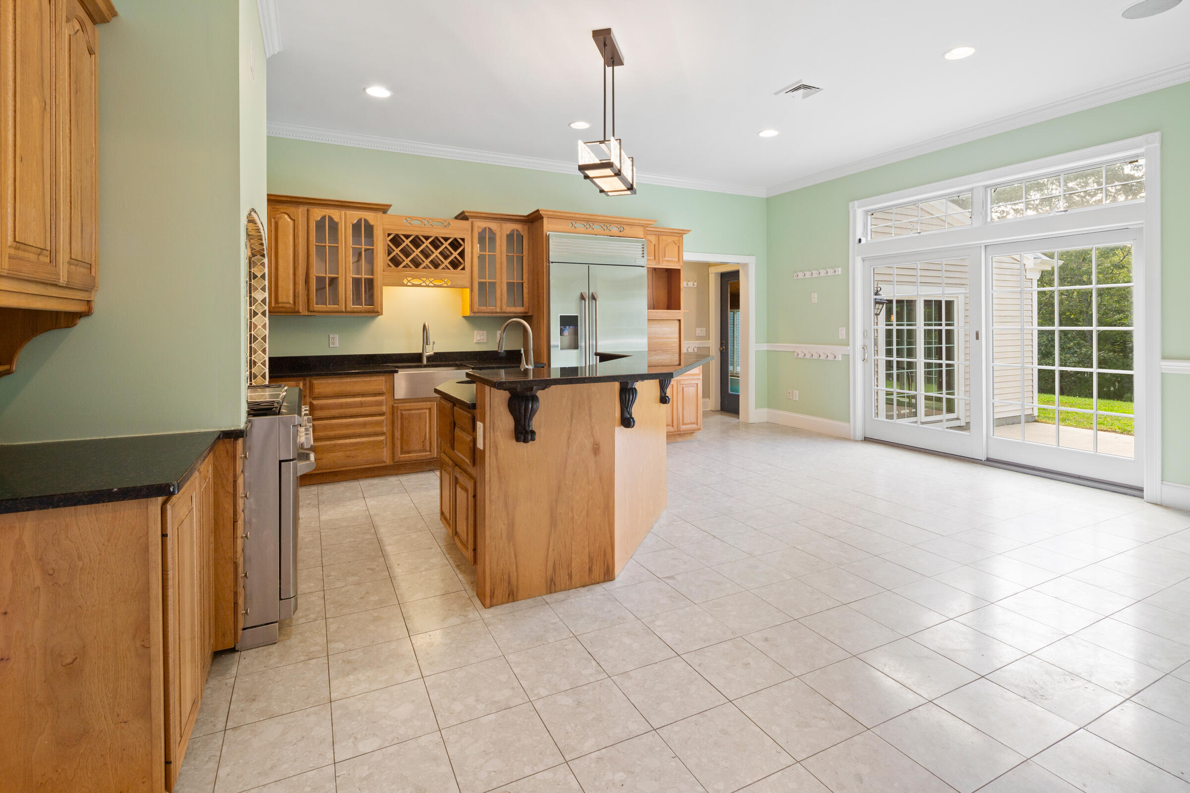 8 Desmond Road Sagamore, MA 02561 - Photo 19 of 71 a view of a kitchen with kitchen island a counter top space a sink stainless steel appliances and cabinets
