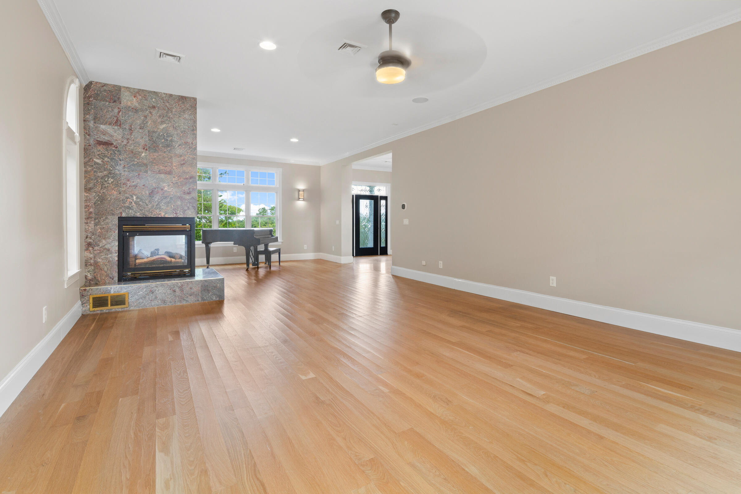8 Desmond Road Sagamore, MA 02561 - Photo 10 of 71 an empty room with wooden floor and a fireplace