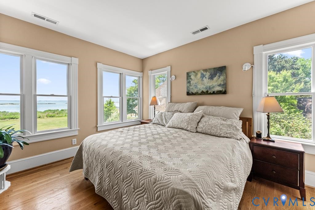 2414 Windmill Point Road White Stone, VA 22578 - Photo 27 of 72 a bed sitting in a bedroom next to a window
