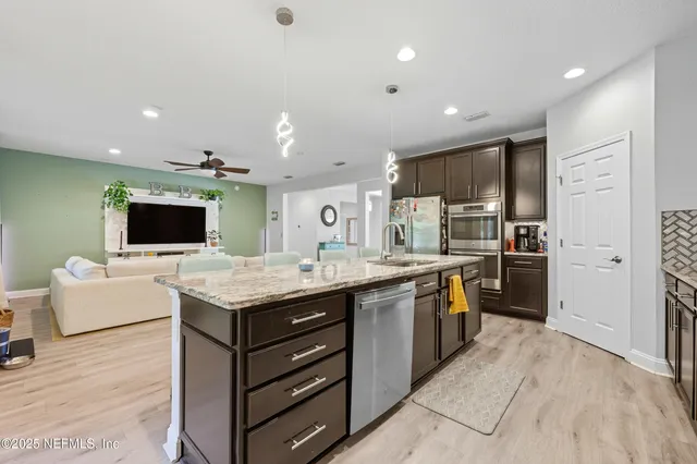 a kitchen with a sink and refrigerator