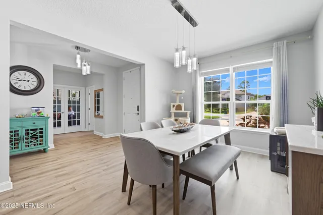 a view of a dining room with furniture window and wooden floor