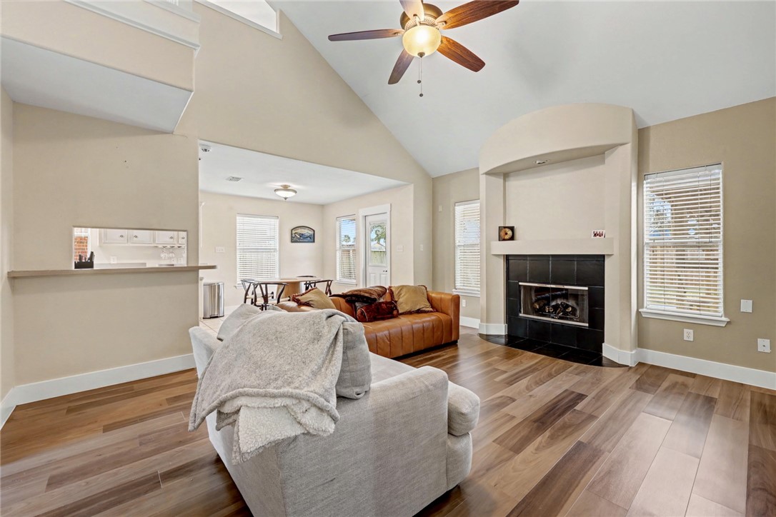 7541 Yorkshire Drive Corpus Christi, TX 78413 - Photo 14 of 32 a living room with furniture a fireplace and a flat screen tv