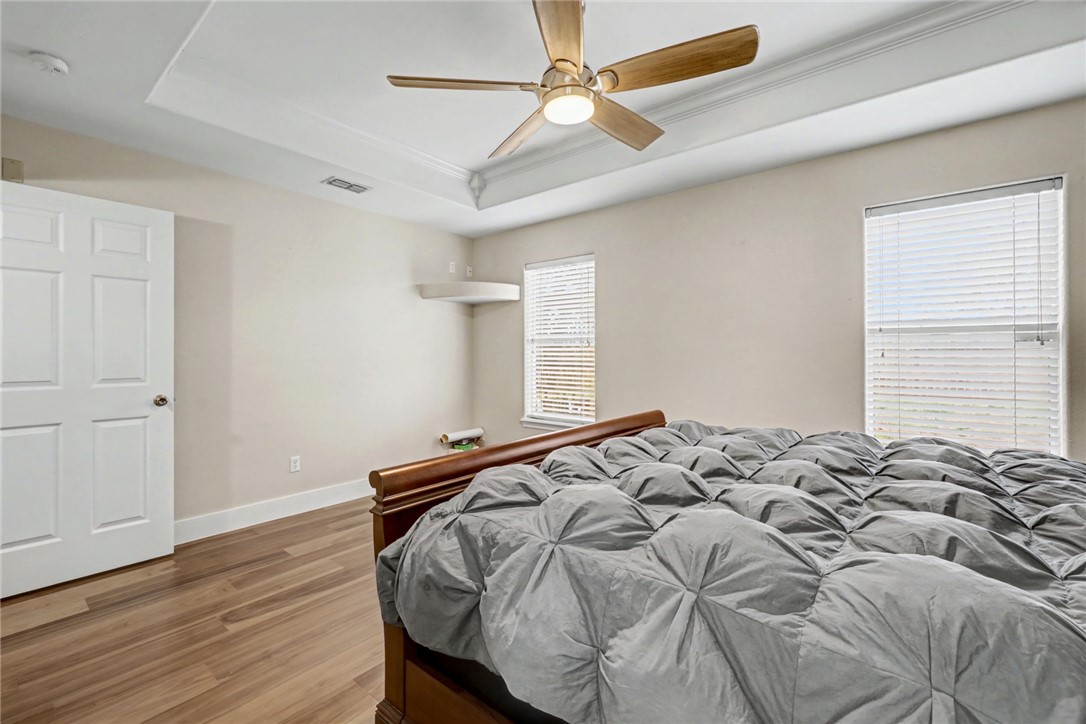 7541 Yorkshire Drive Corpus Christi, TX 78413 - Photo 17 of 32 a bed sitting in a bedroom next to a window and a chandelier