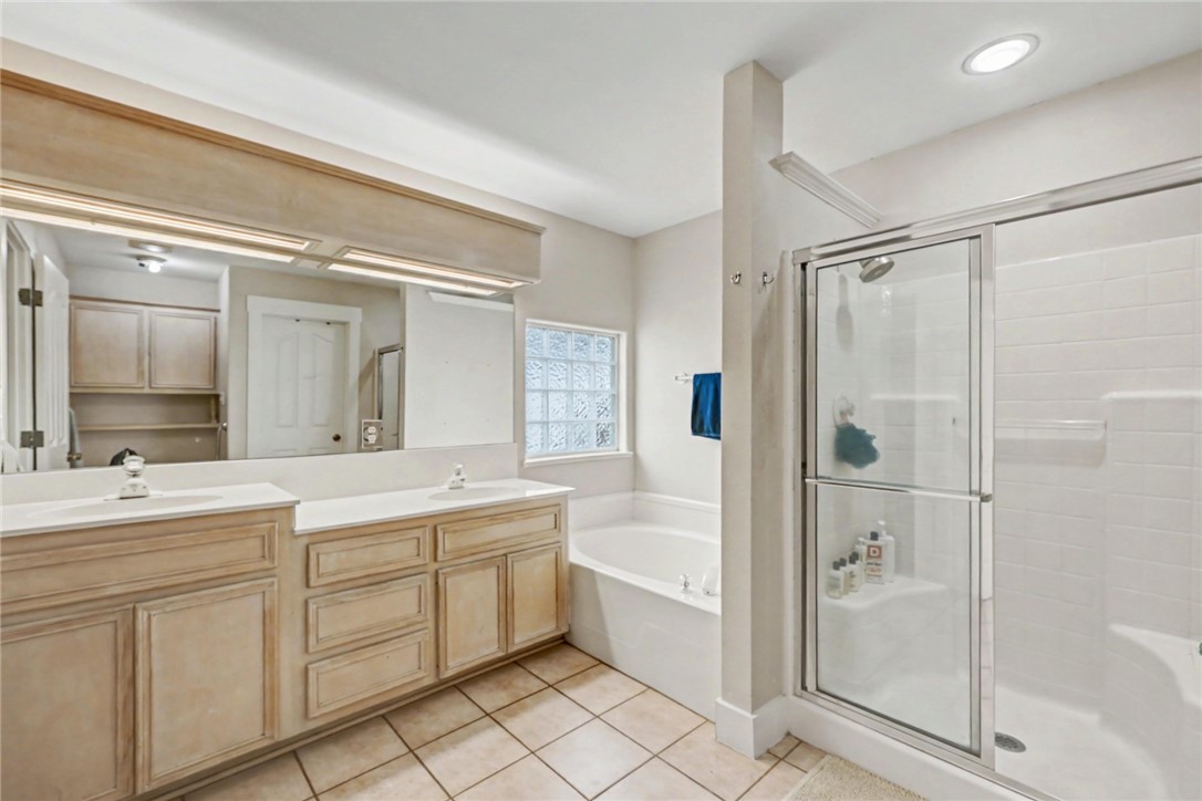 7541 Yorkshire Drive Corpus Christi, TX 78413 - Photo 19 of 32 a bathroom with a double vanity sink mirror and shower