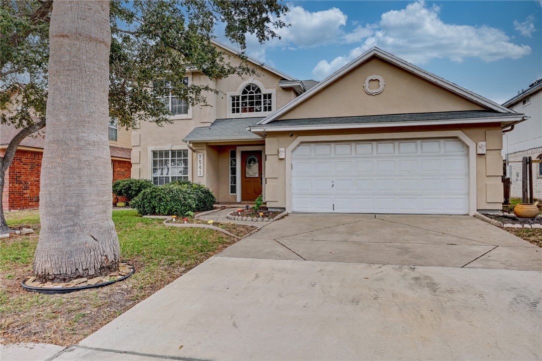 7541 Yorkshire Drive Corpus Christi, TX 78413 - Photo 2 of 32 a front view of a house with a yard and garage