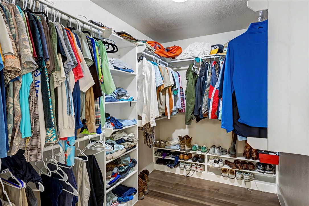 7541 Yorkshire Drive Corpus Christi, TX 78413 - Photo 21 of 32 a view of walk in closet with clothes